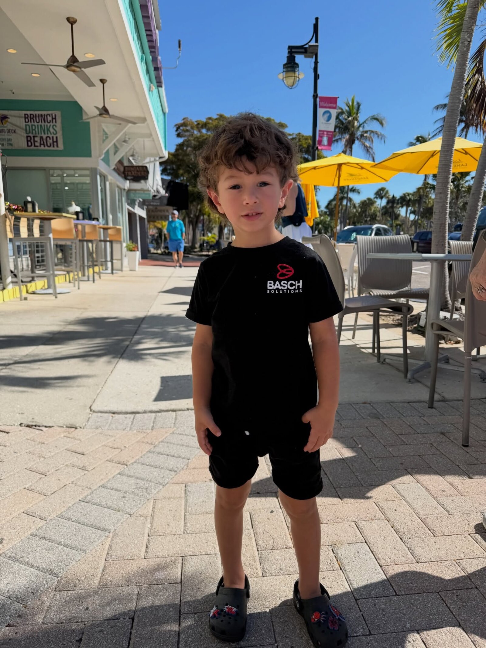 A Basch family member in a Basch Solutions t-shirt at the Sarasota beach — locally based digital agency